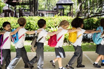 Kindergarten students walking together in school
